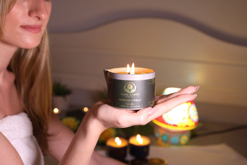 model holding massage oil candle 