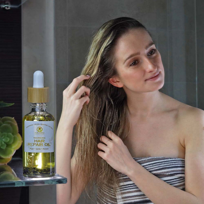 model putting hair repair oil in hair